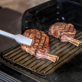 Traeger ModiFIRE sear grate side view highlighting reversible design for flat searing.