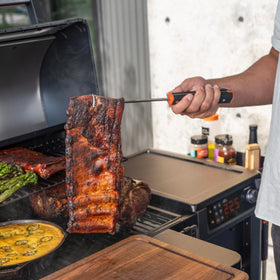 Traeger Pig Tail Flipper shows sturdy handle and loop for safe grilling.