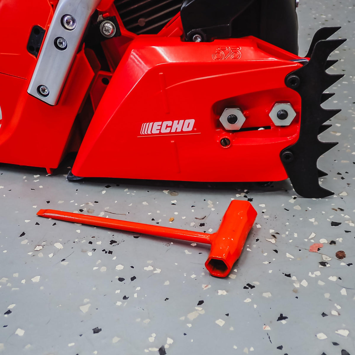 Two-wrench set demonstrates 13mm and 19mm compatibility with chainsaws.