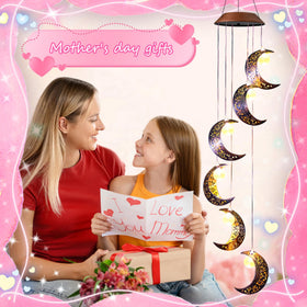 Close-up of the moon pendant on Tryme windchime glowing softly