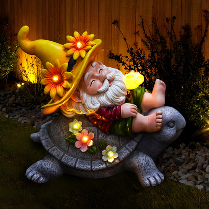 TUEVAK garden gnomes with solar sunflower on turtle and coffee glow in outdoor space.