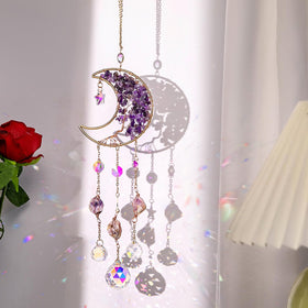 TUOKING amethyst moon suncatcher on a sunny window casting colorful rainbows.