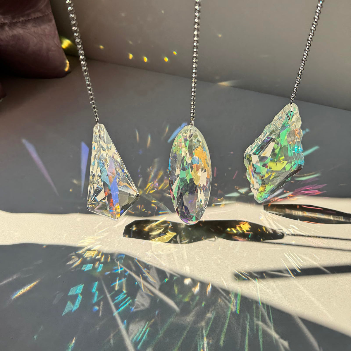 TXXNSM crystal sun catcher prism hangs in garden producing colorful reflections