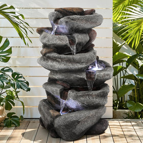 Ultym five-tier rock waterfall adds depth to patio evenings.