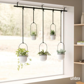 Umbra Triflora shows adjustable cords for customizable pot placement along the rod.