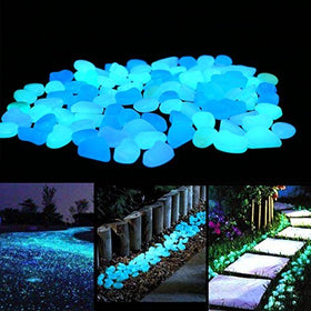 Unime glow-in-the-dark garden pebbles illuminate a garden path with blue glow for safer night walking