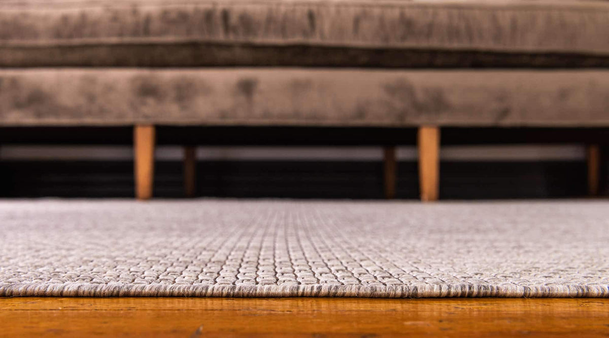 Unique Loom outdoor-ready flatweave rug in beige ivory, ideal for patios.