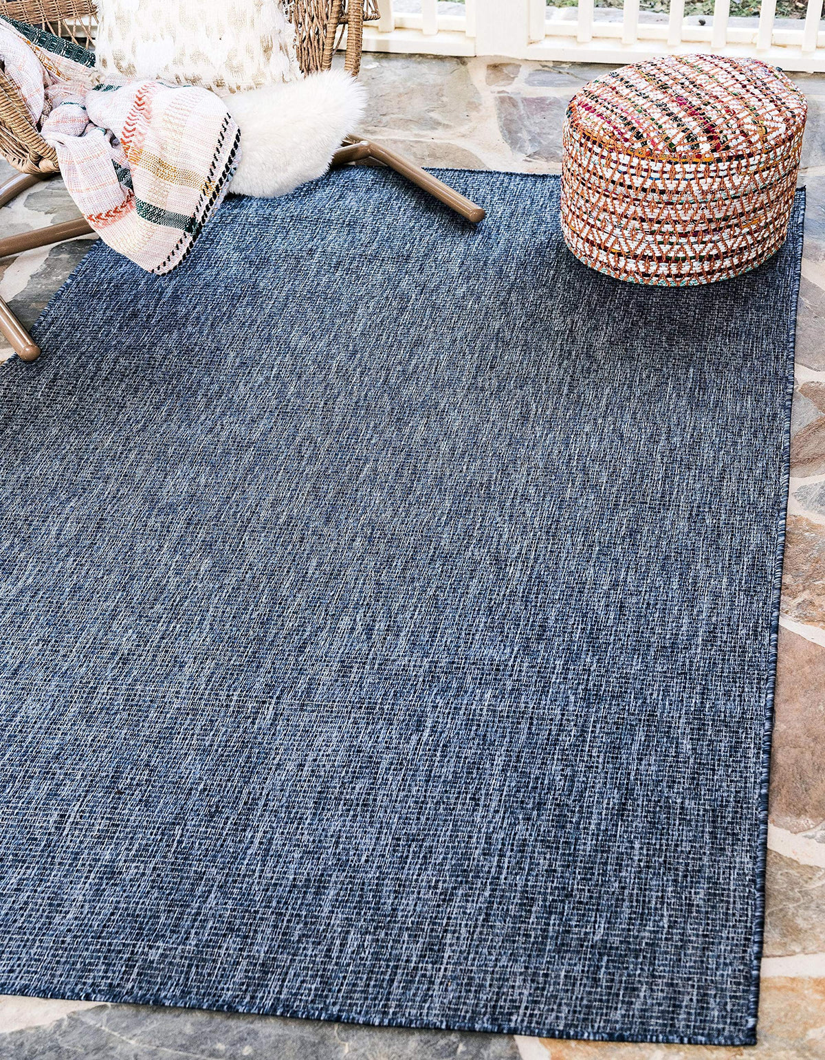 Unique Loom flatweave rug near patio seating, easy maintenance.