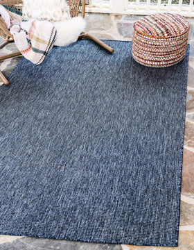 Unique Loom flatweave rug near patio seating, easy maintenance.