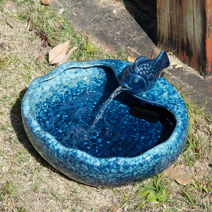 UPSJYJ ceramic solar fountain bird bath with koi fish decor attracts birds and enhances garden charm.