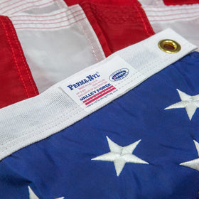 Left-edge brass grommets secure the flag to a pole.