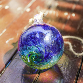 VCUTEKA 6-inch gazing ball enhances garden decor with shimmering colors at dawn and dusk.