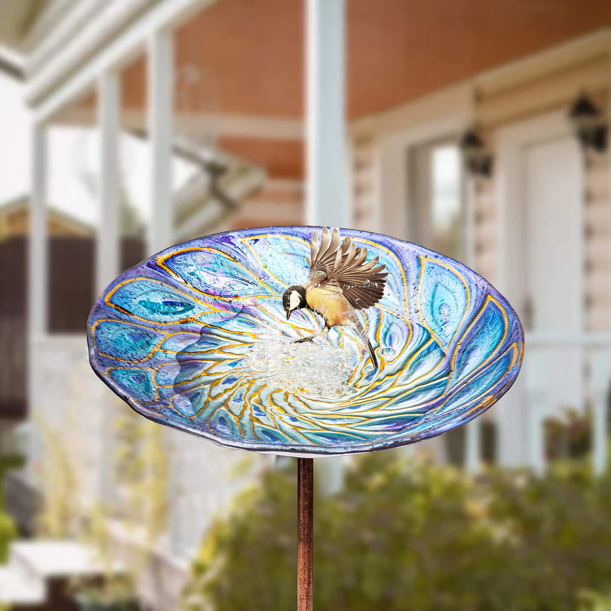 VCUTEKA glass bird bath with stainless steel base stays stable outdoors.
