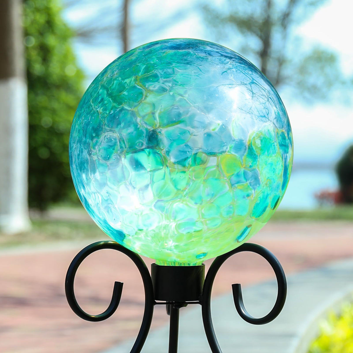 VCUTEKA glass sphere garden ornament blue swirl near plants
