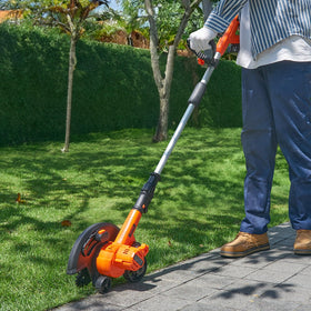 VEVOR 9-inch blade slices through tall grass with steady control.