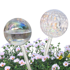 Vividaire iridescent glass watering globe in hand enables easy travel-friendly plant care