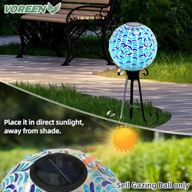 VOREEN mosaic glass globe glows at night, creating a serene garden ambiance.