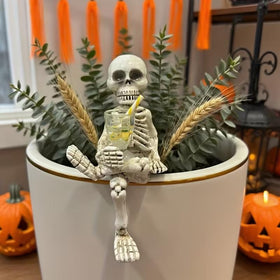 WACSLDN compact skeleton figure pairs with small planters and pots.