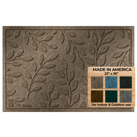 WaterHog leaf-design welcome mat in camel traps dirt at the threshold
