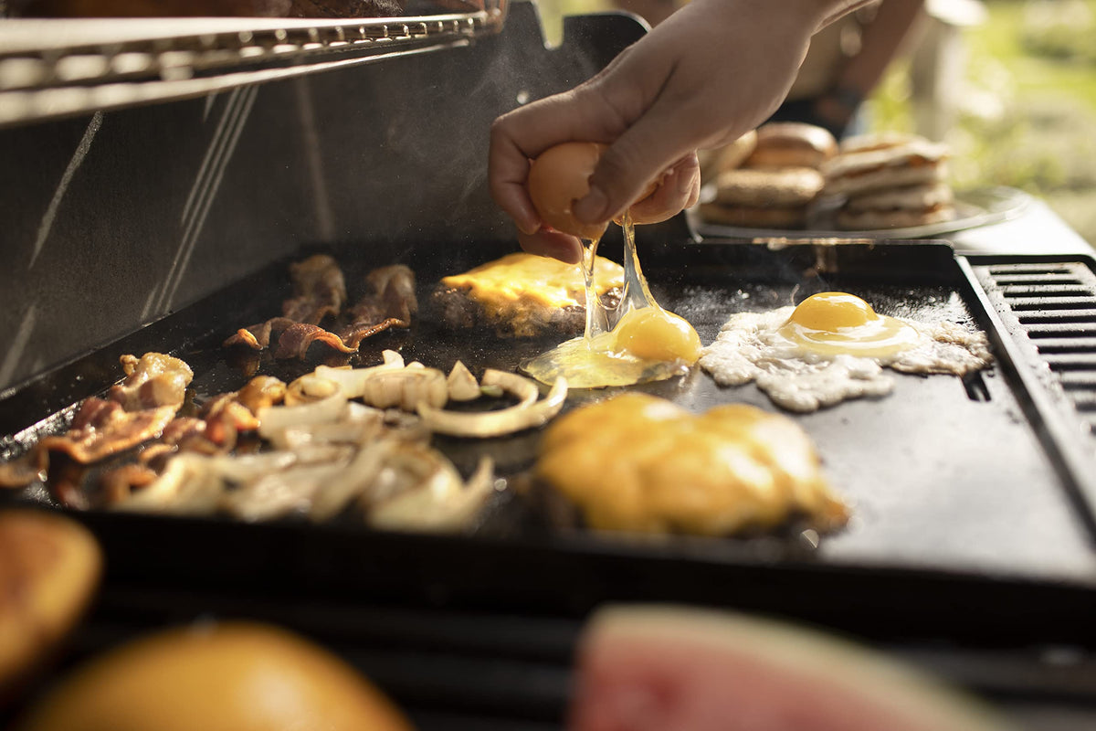 Weber Crafted eggs and vegetables sizzling on warp-resistant carbon steel.
