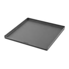 Weber Crafted flat-top griddle mounted on grill for versatile outdoor cooking.