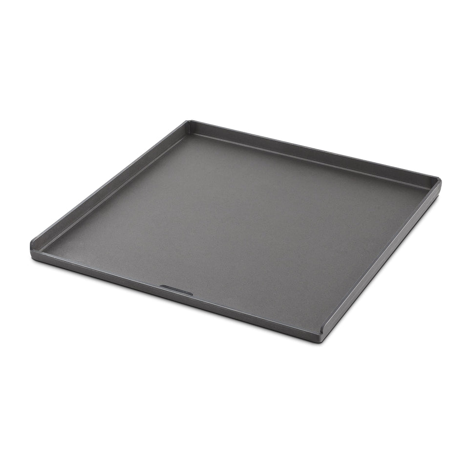 Weber Crafted flat-top griddle mounted on grill for versatile outdoor cooking.