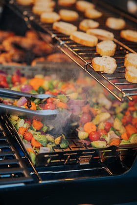 Weber Crafted Roasting Basket holding delicate seafood securely.