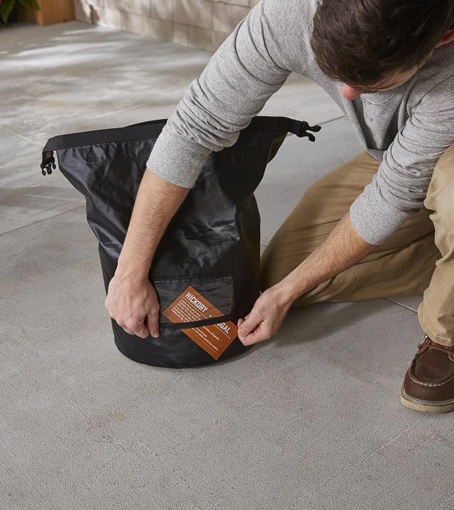 Weather-resistant Weber bag protects fuel from rain during outdoor cooking