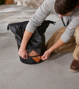 Weather-resistant Weber bag protects fuel from rain during outdoor cooking