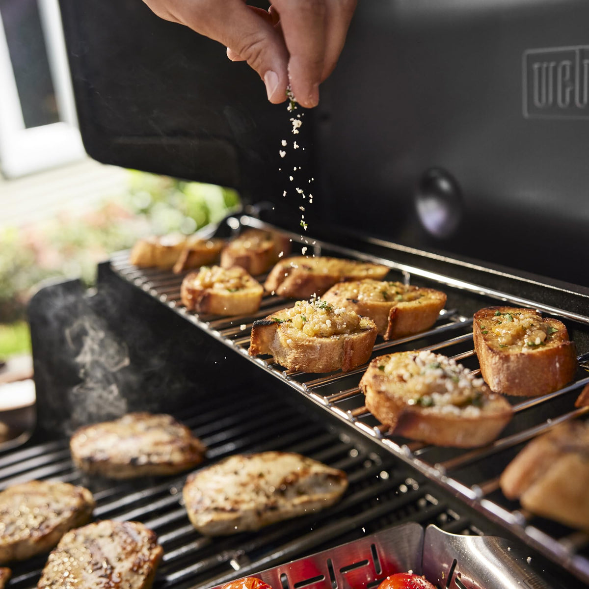 Flavorizer bars on the Weber Genesis E-325 boost flavor while directing juices away from burners.