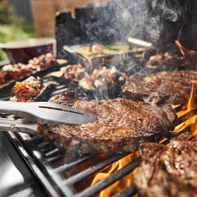 Weber Genesis E-335 grill locker stores tools and grillware for organization.