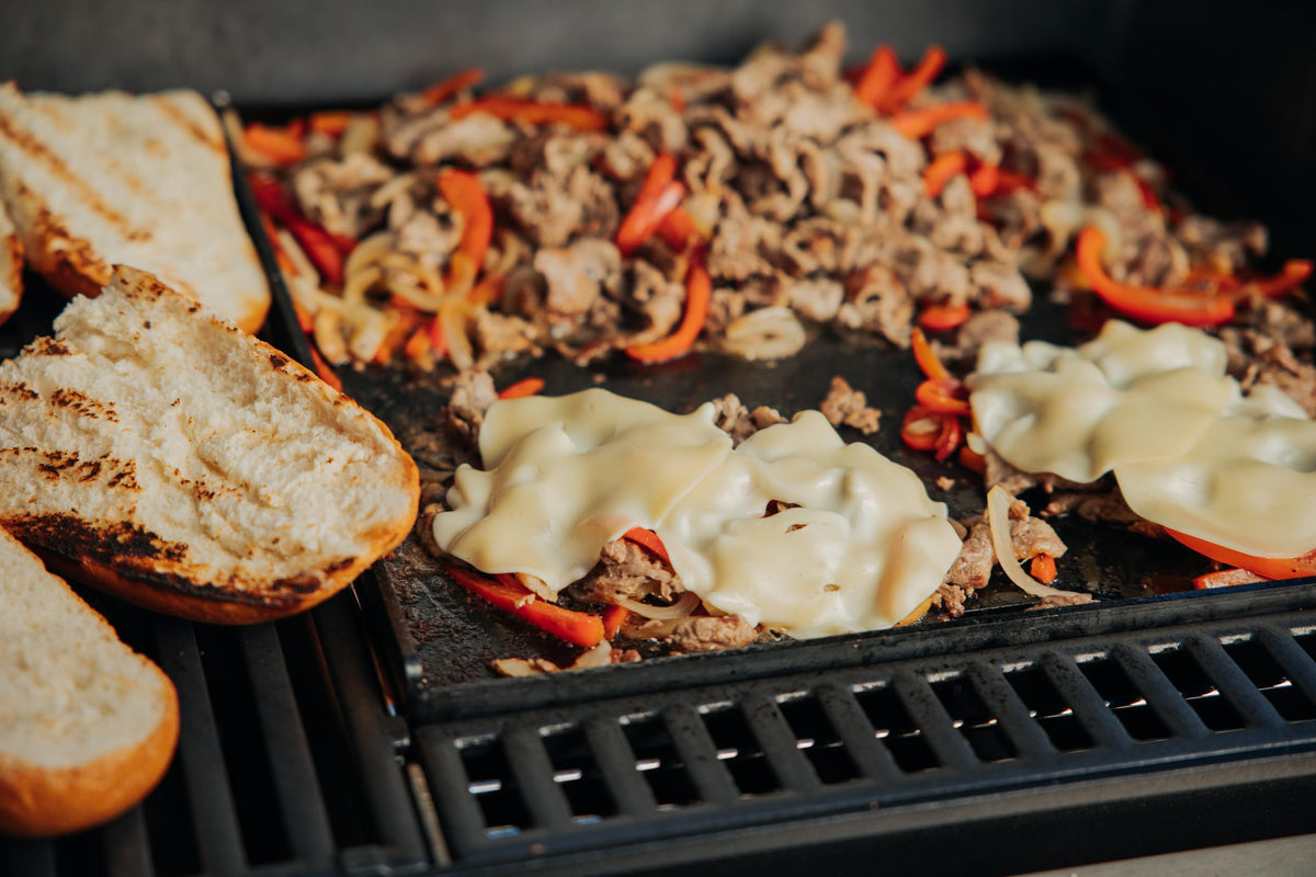 Bacon and burgers sizzling on Weber Crafted griddle insert.