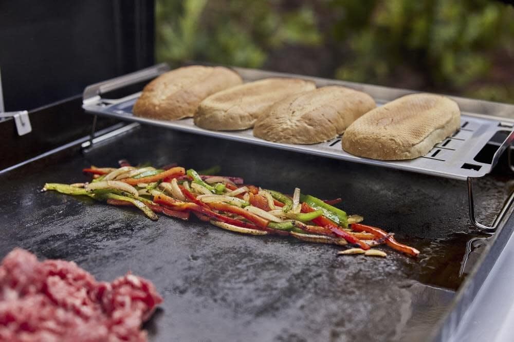 Weber Griddle Warming Rack collapsible-legs stores compactly after cooking.