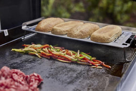 Weber Griddle Warming Rack collapsible-legs stores compactly after cooking.