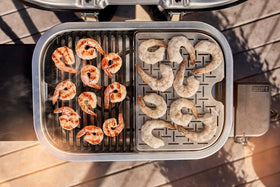 Weber Lumin Compact grill black finish blends with outdoor décor.