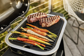 Weber Lumin Compact grill control knobs emphasize precise sear and steam settings.