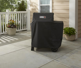 Weber Searwood 600 cover with fastening straps for secure, easy setup.
