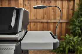Weber Works Flex Light clips to side tables for hands‑free lighting
