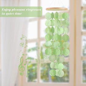24-inch capiz windchime showcases round shells and a natural wood top.