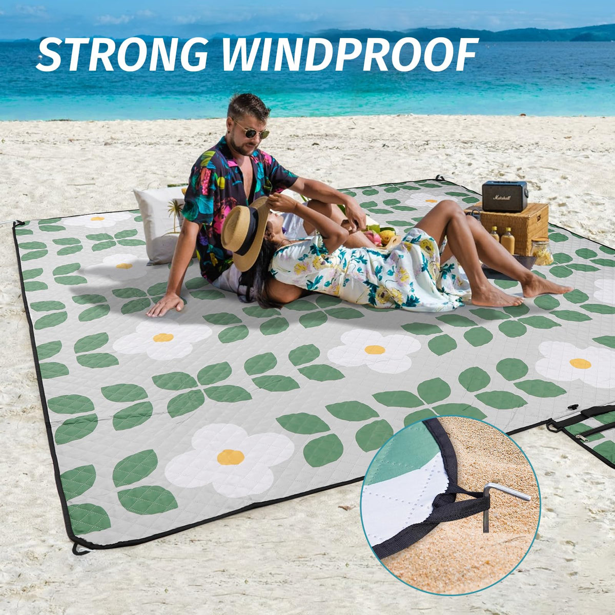 WICKERLAND picnic blanket includes stakes to secure on windy days.