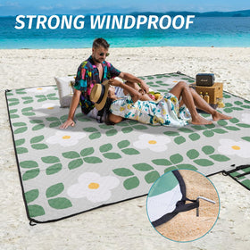 WICKERLAND picnic blanket includes stakes to secure on windy days.