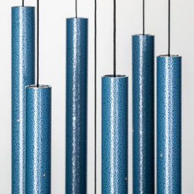 Wind River Corinthian Bells sky blue chime on a sunlit patio
