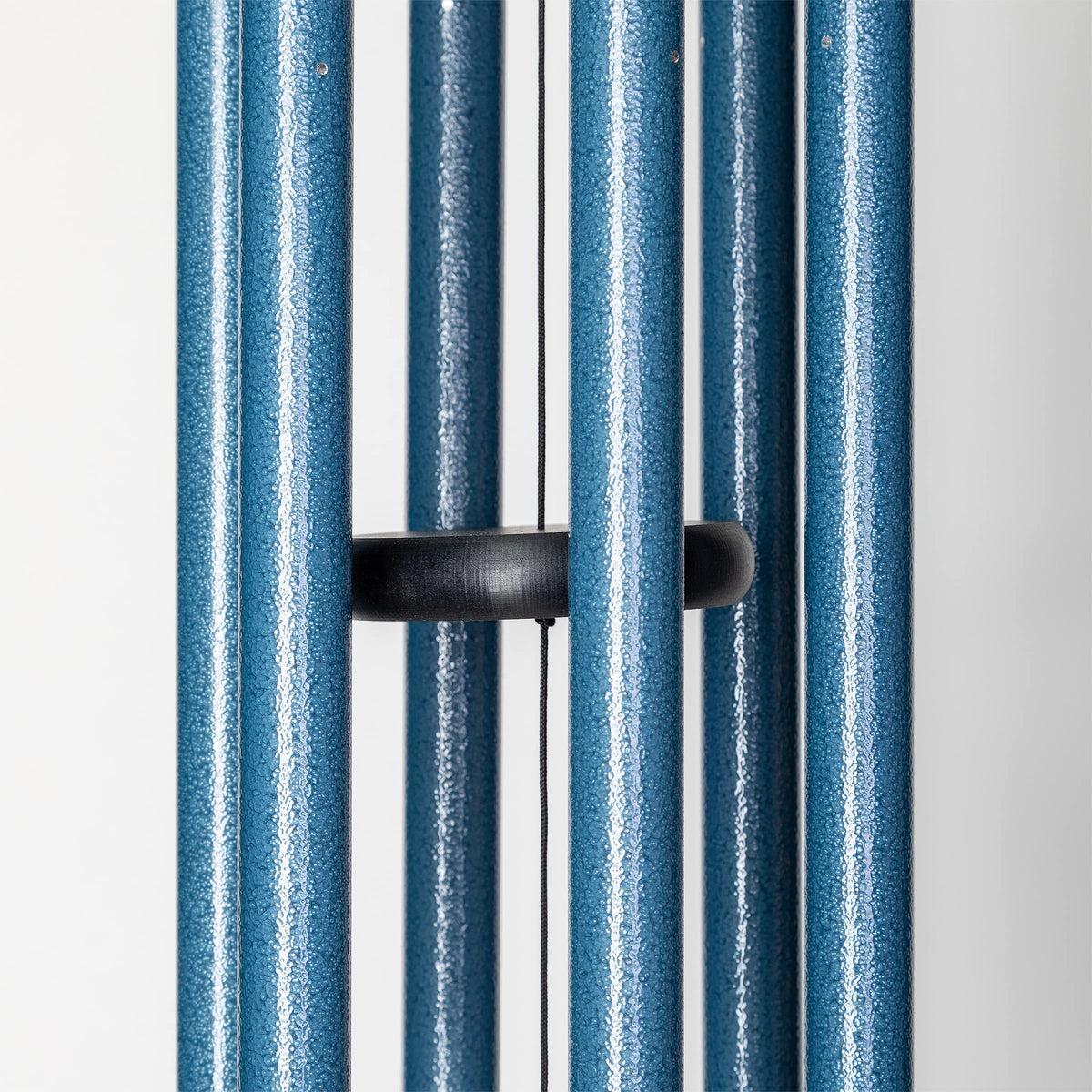 Sky blue Wind River chime lighting a garden scene