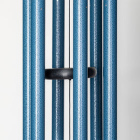 Sky blue Wind River chime lighting a garden scene