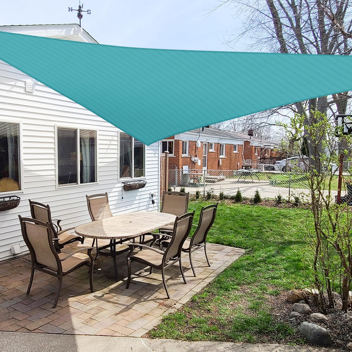 Windscreen4less turquoise triangle sun shade sail installed in backyard for shade