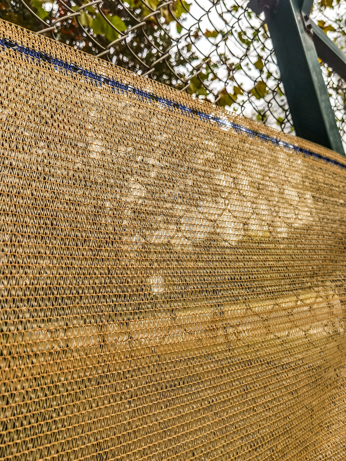 WindscreenSupplyCo shade cloth installation with blue-highlighted eyelets for quick setup