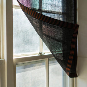 Rinsing Winemana shade cloth with hose for easy cleaning.