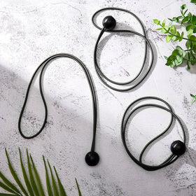 Woanger beach and patio tie helps keep rolled carpets and tent poles tidy
