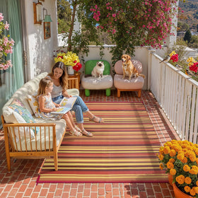 WondRg outdoor plastic straw rug with red-orange stripe adds durable porch comfort.