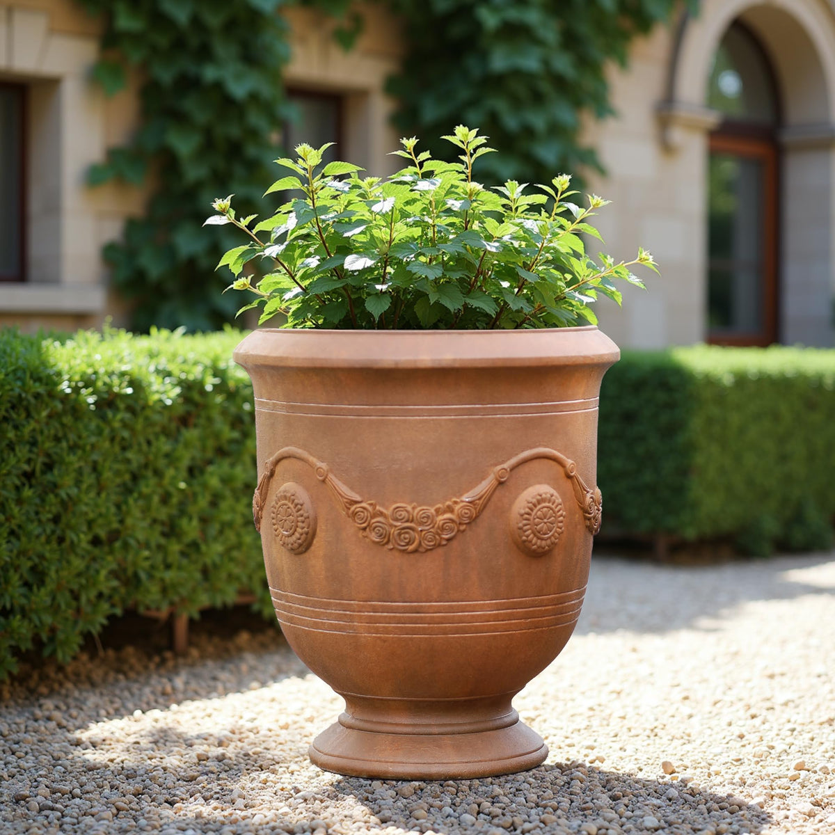 Worth Garden Large Urn Planter cement texture with rust finish adds rustic charm